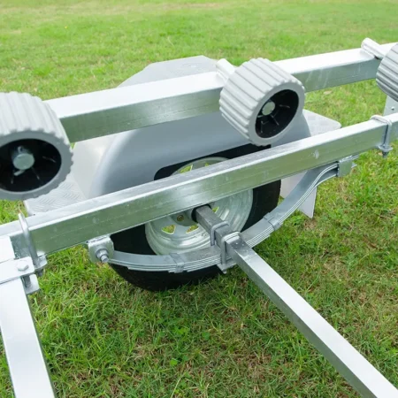 Close-up of heavy-duty leaf spring suspension and wheel guard