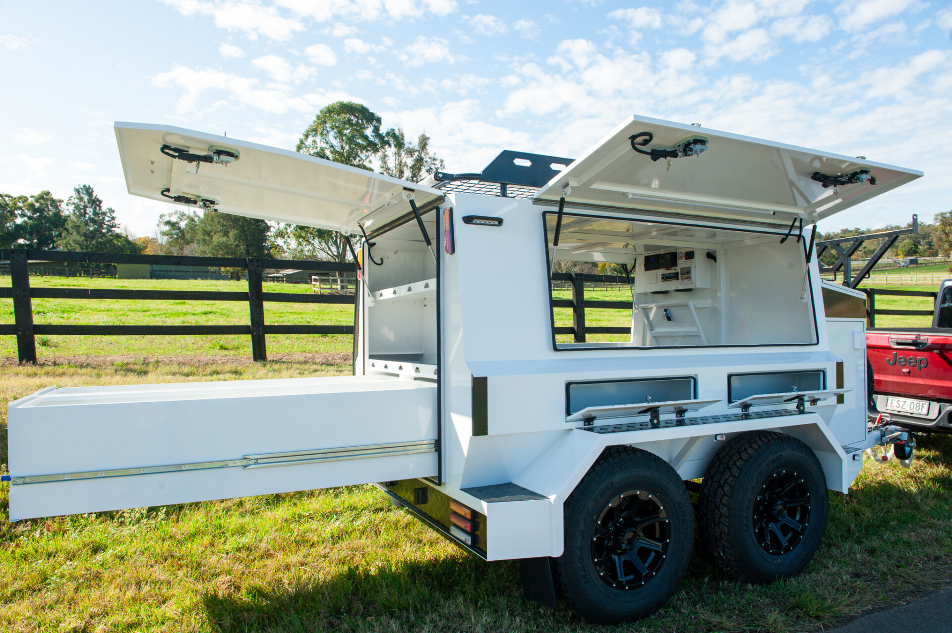 Trade King Builder Trailer with storage compartments open